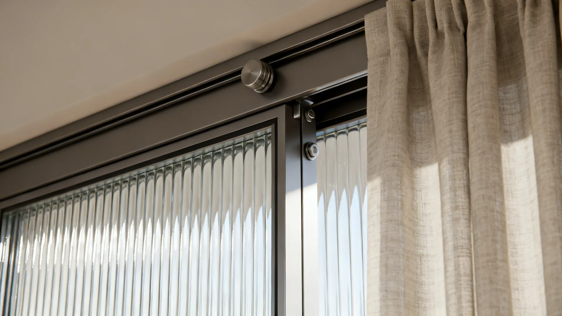 Close up of a black sliding door with textured glass panels and a beige curtain