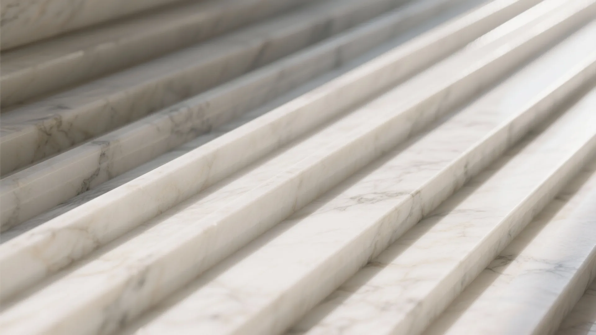 Close-up of white marble stairs with grey veins showing smooth natural stone texture in bright light