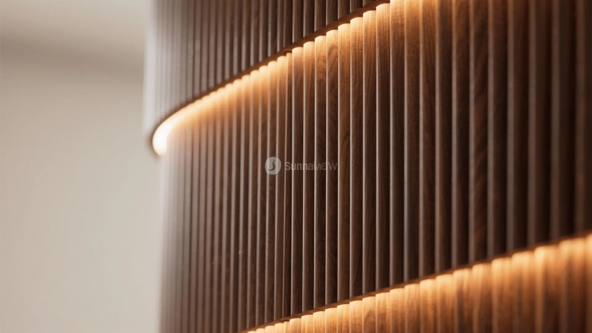 Close up of curved wooden wall panel with hidden warm light strip on modern interior wall