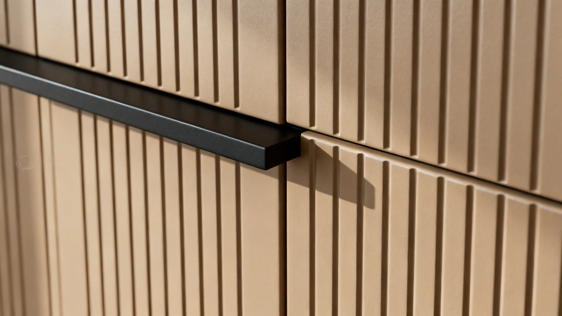 Close-up of fawn fluted cabinet grooves and slim matte black rail