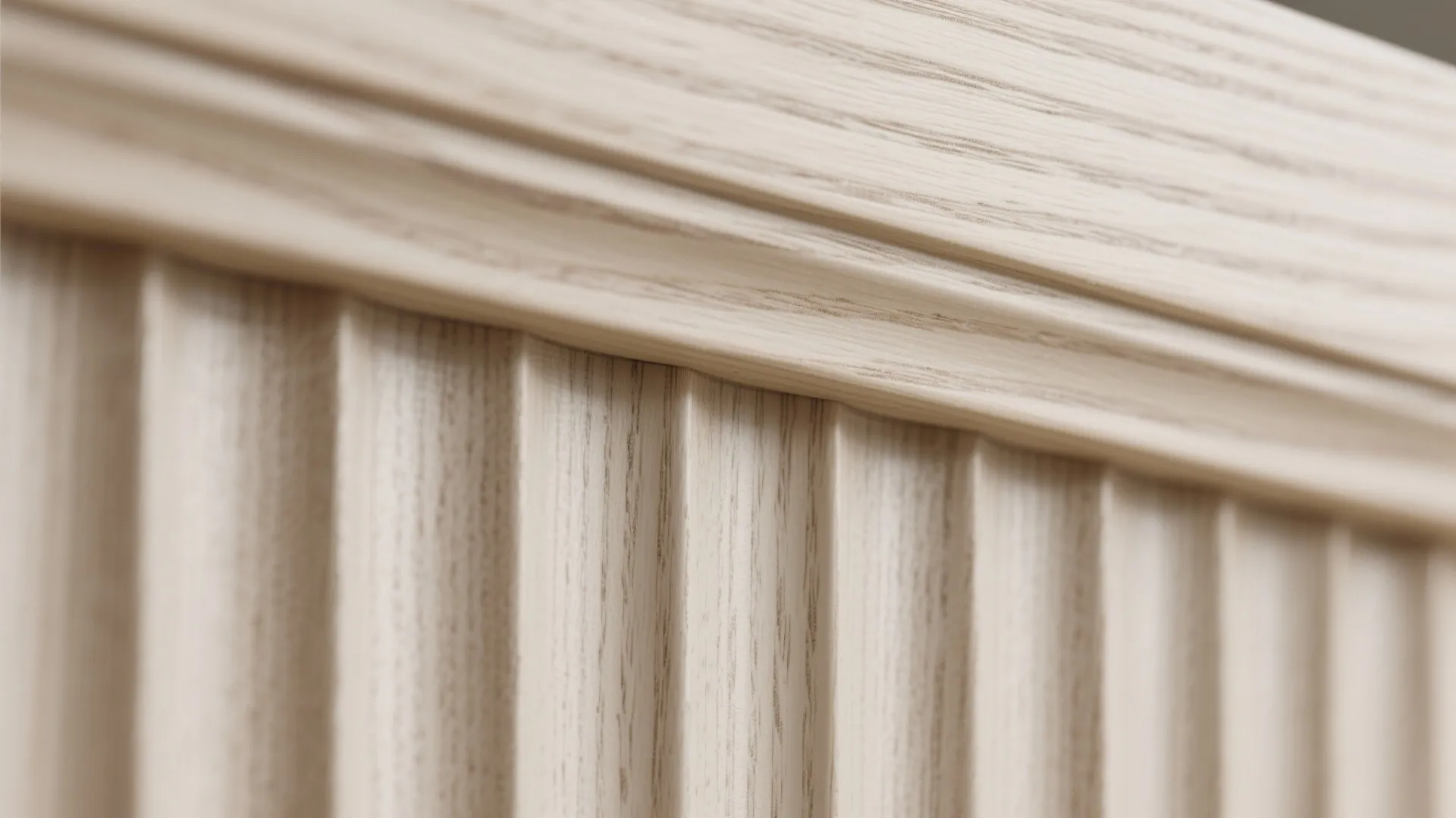 Macro of fluted white-oak veneer showing grain and rounded edge banding.