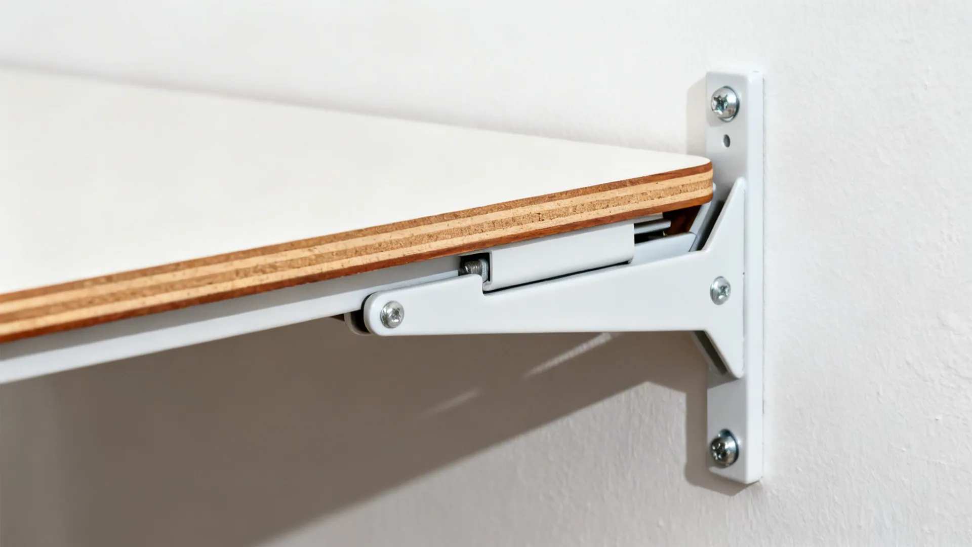 Macro of a heavy-duty folding bracket supporting a hardwood-edged fold-down table.