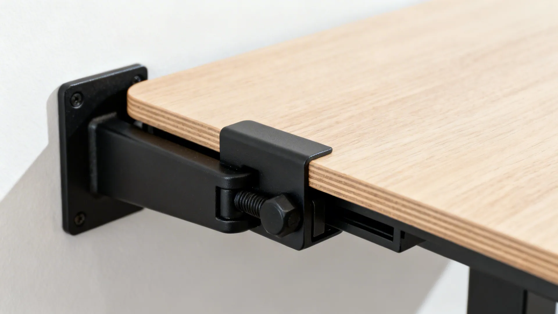 Close-up of a robust locking bracket supporting a fold-down table in light wood.