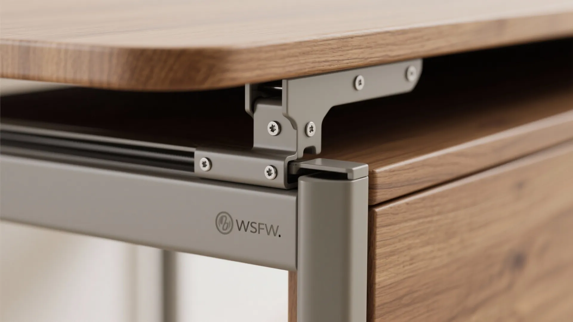 Close up of a grey metal hinge connecting a wooden desk top to the frame