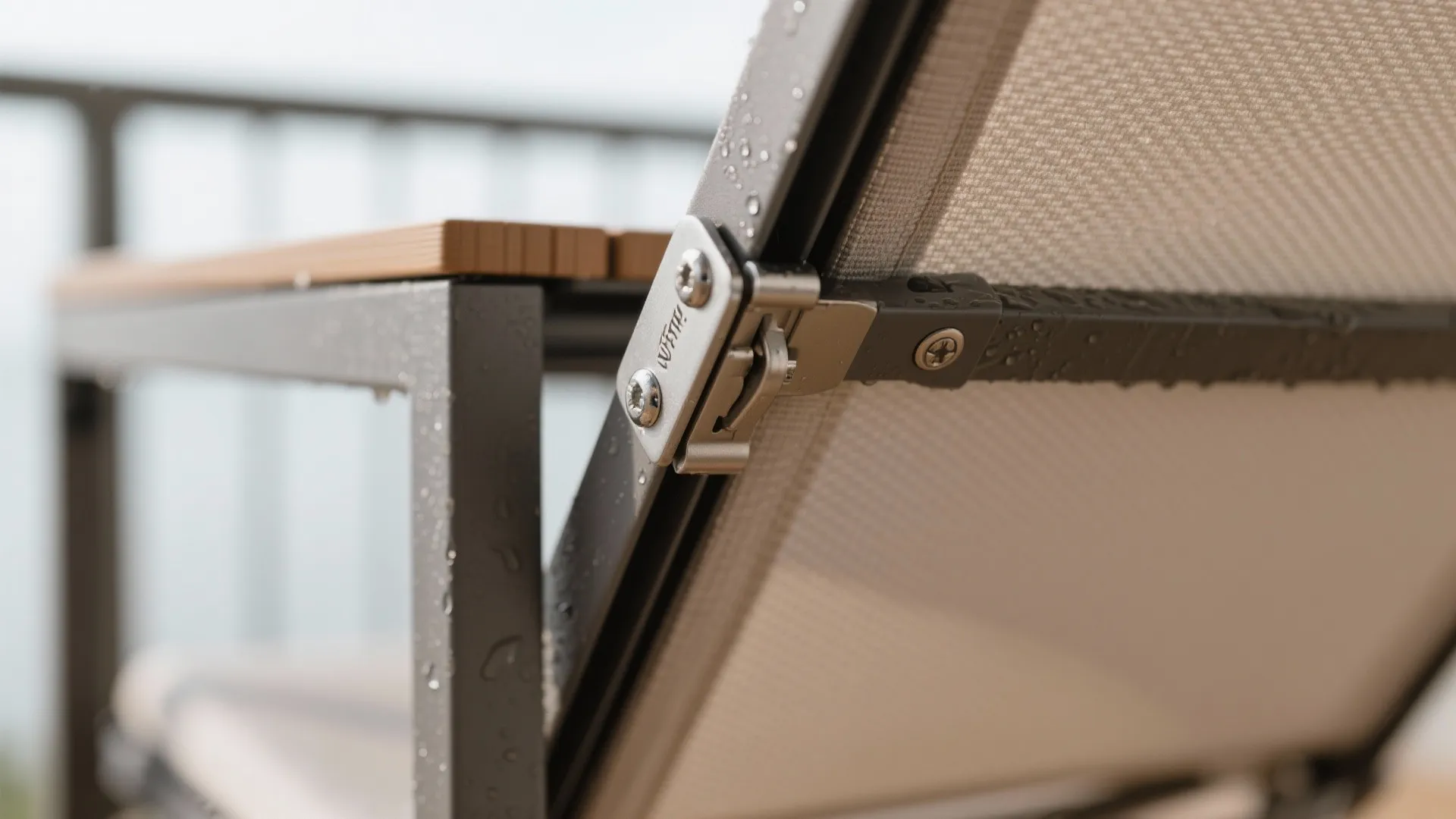 Macro of marine-grade hinge and latch on a fold-down balcony table with powder-coated frame.