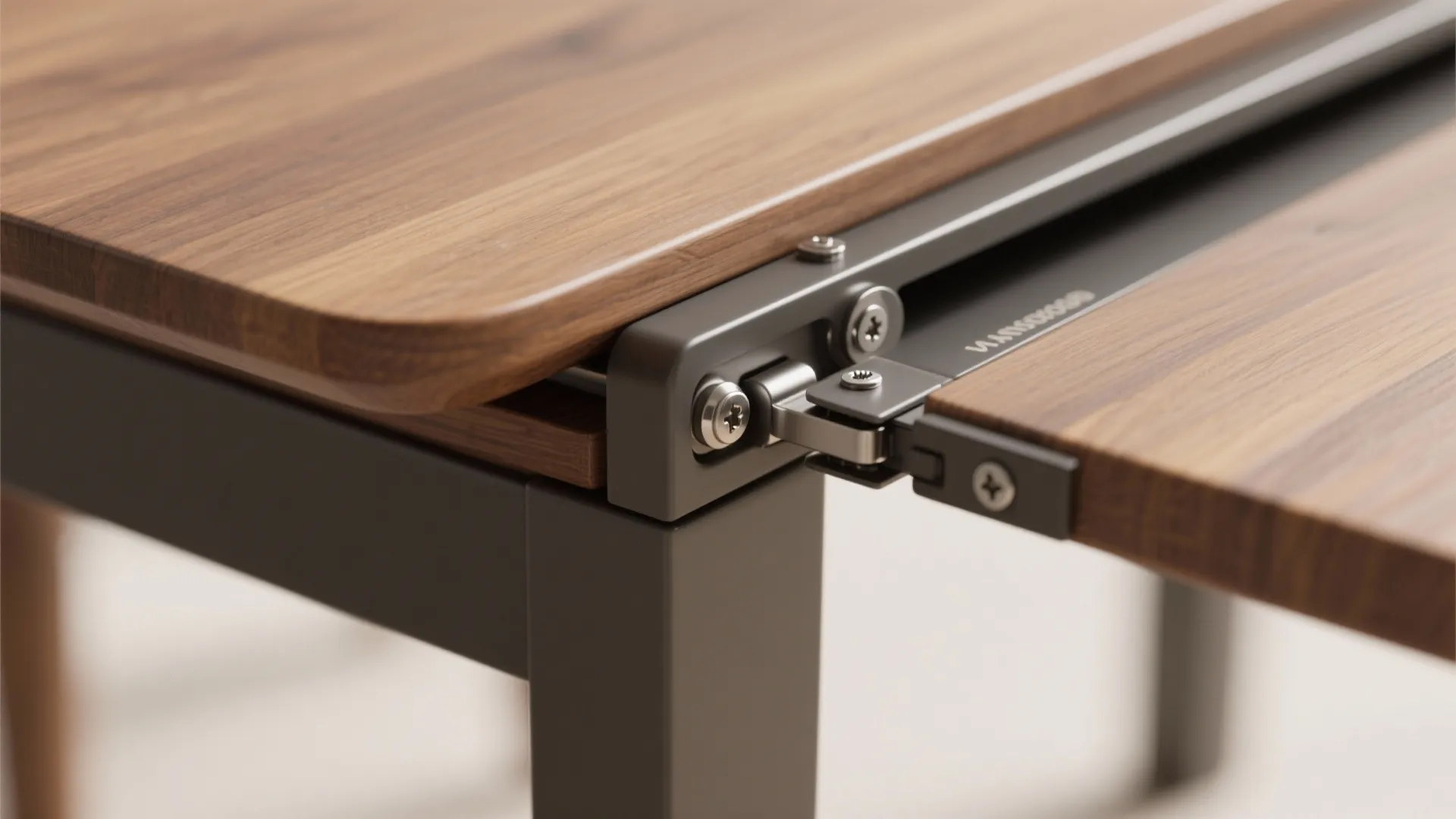Metal foldable hinge connecting two wooden table pieces with silver screws on a grey metal frame