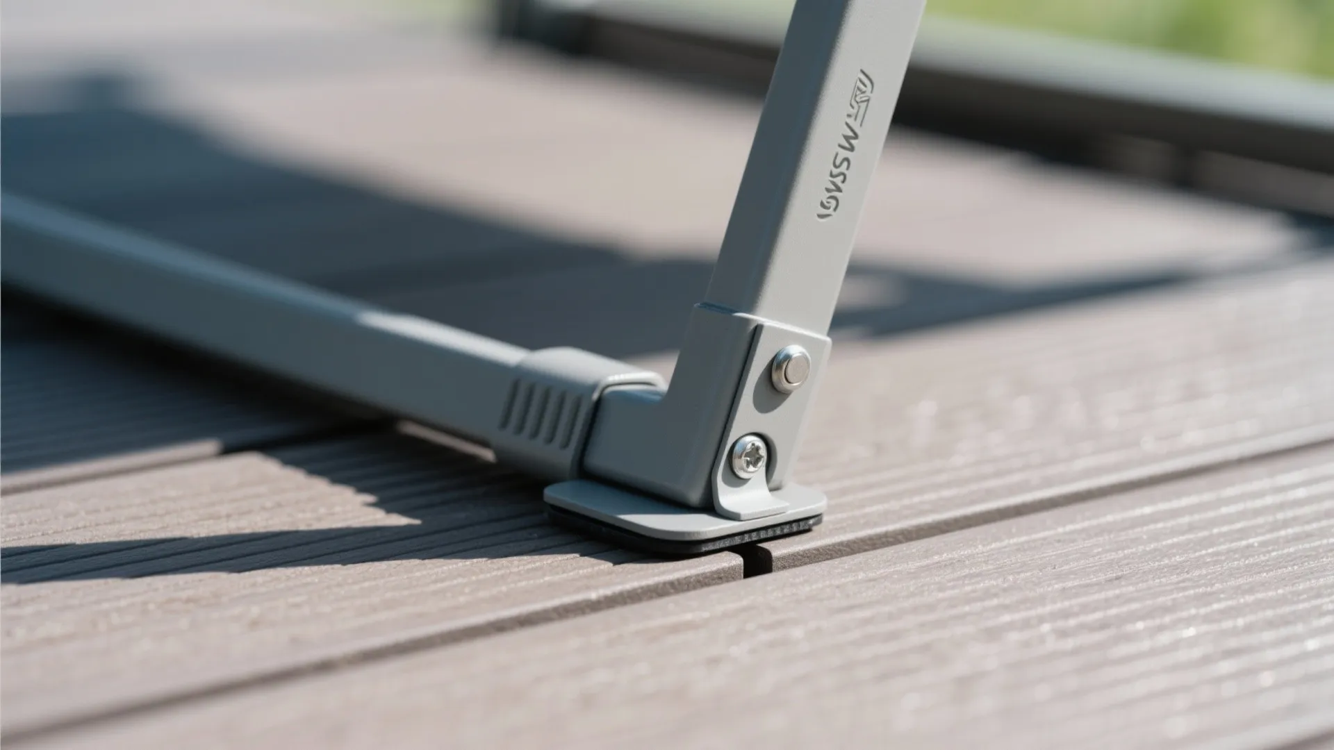 Close-up of foldable chair hinge and protective glide on composite tile flooring.