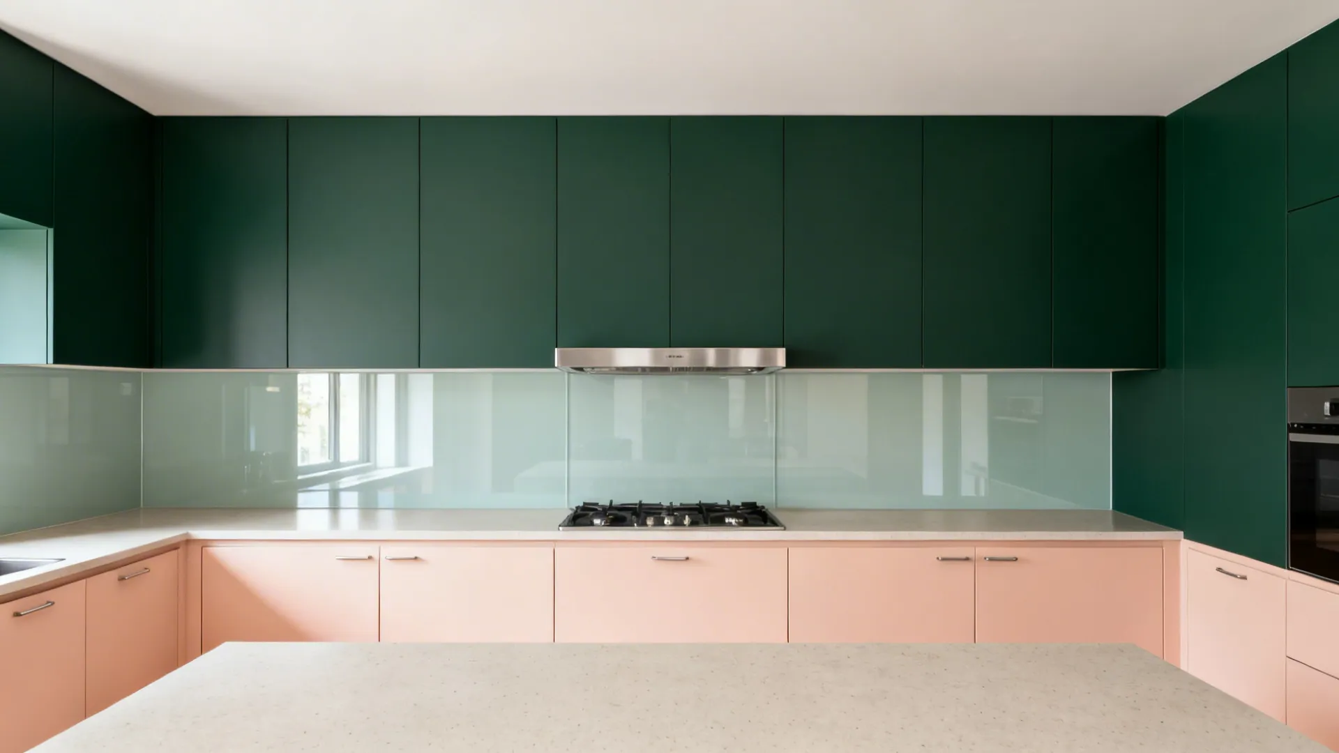 Two-tone kitchen with forest green uppers and peach base cabinets with glass backsplash.