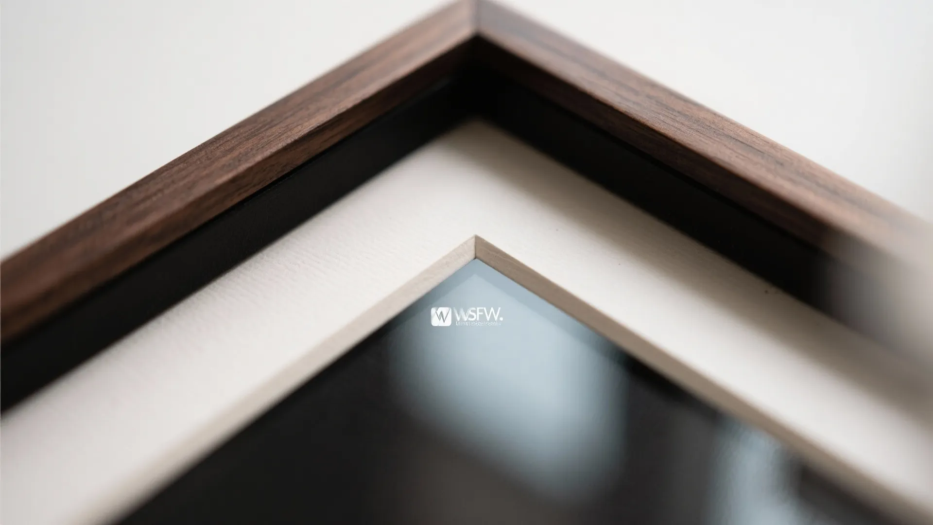 Macro of a matted frame corner with clean miters and soft daylight on a neutral wall.