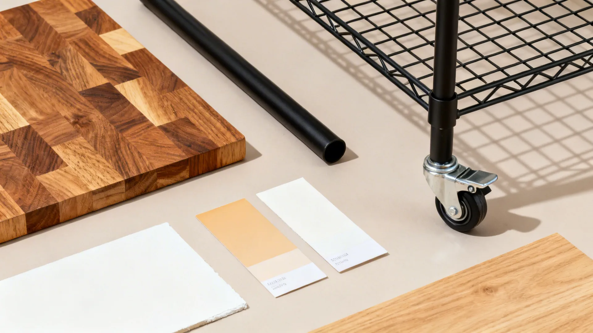 Flat-lay of butcher-block wood, black steel, wire grid, caster, and warm white and oak swatches.