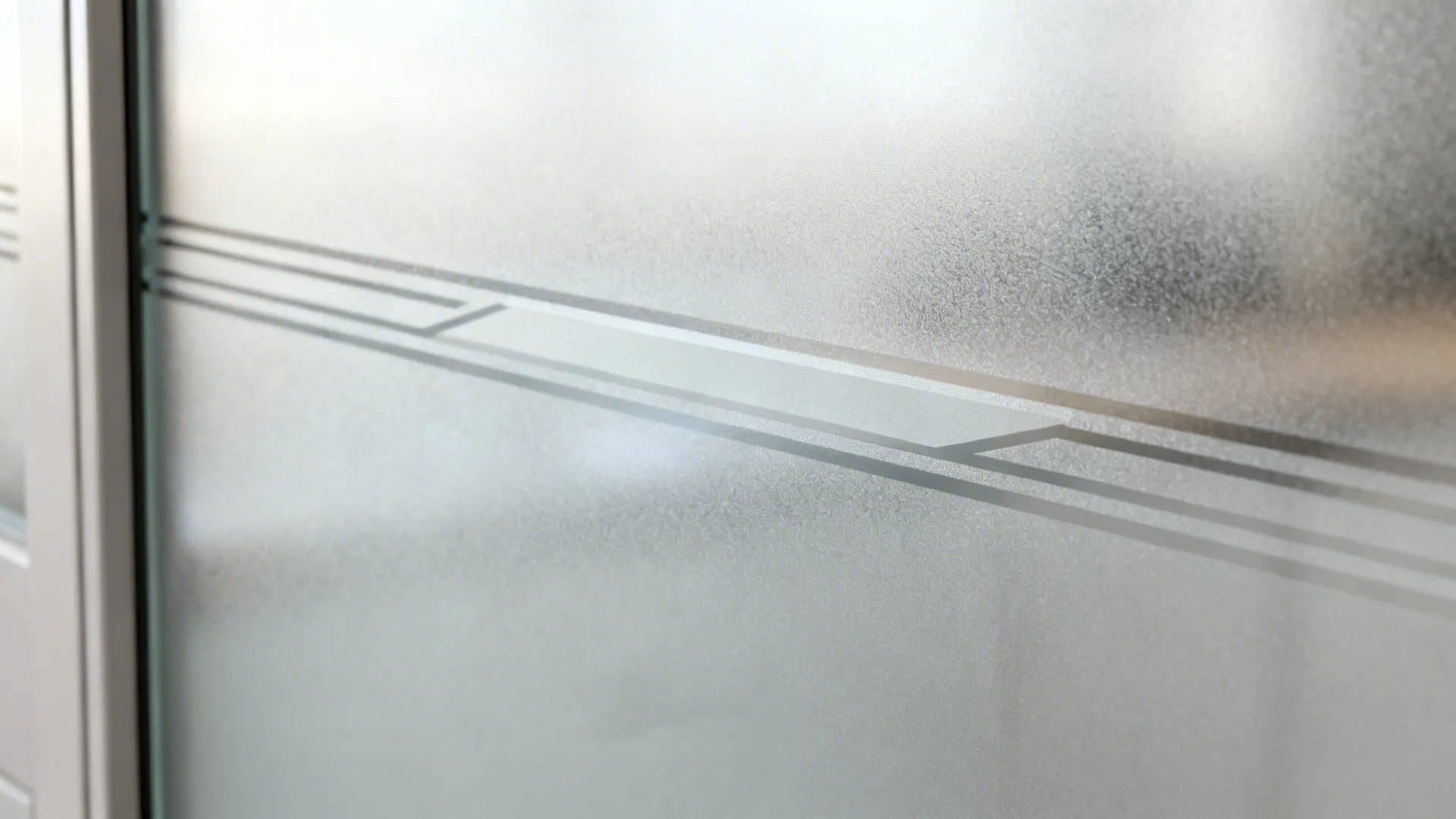 Macro of frosted geometric band on kitchen glass door showing semi-polished texture and soft light gradients.