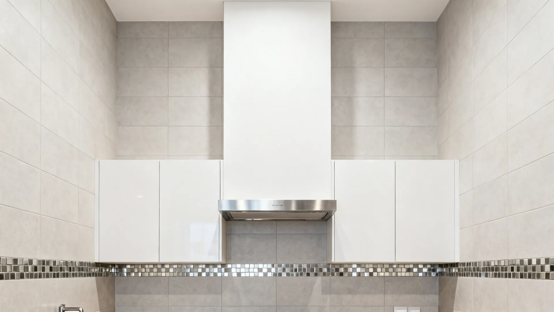 Full-height backsplash with a slim metallic mosaic band aligned to cabinetry in a small kitchen.