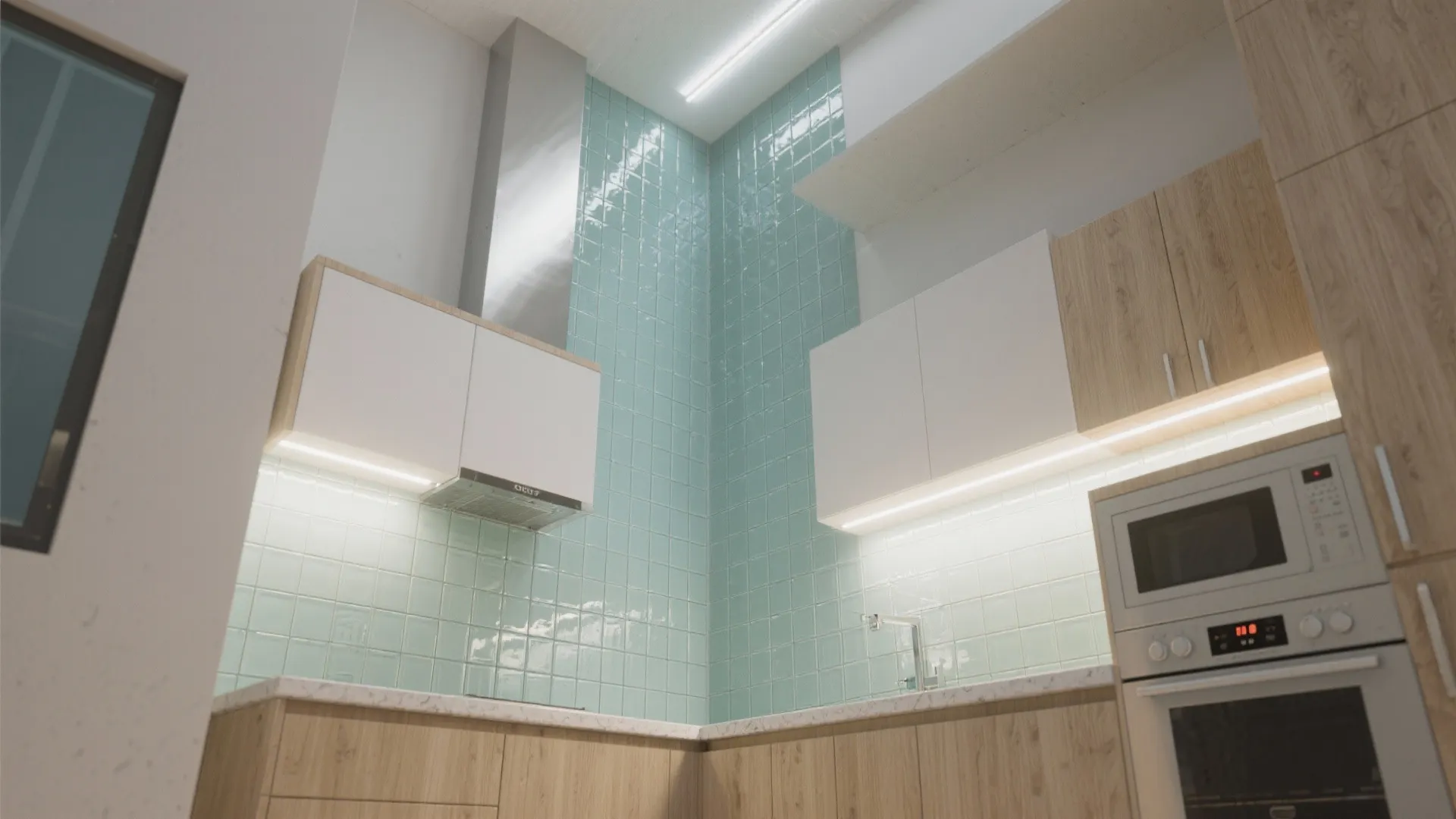 Studio kitchenette with glass tile running from countertop to ceiling creating a seamless reflective plane.