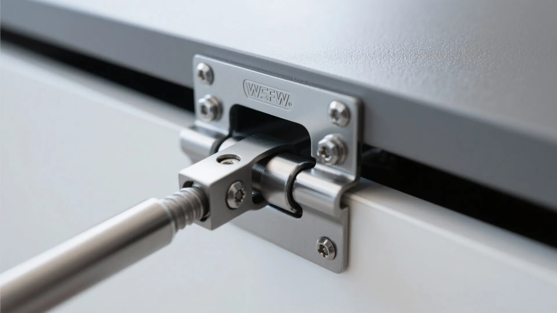 Close-up of a gas-lift hinge and cross-support on a lift-top chest.