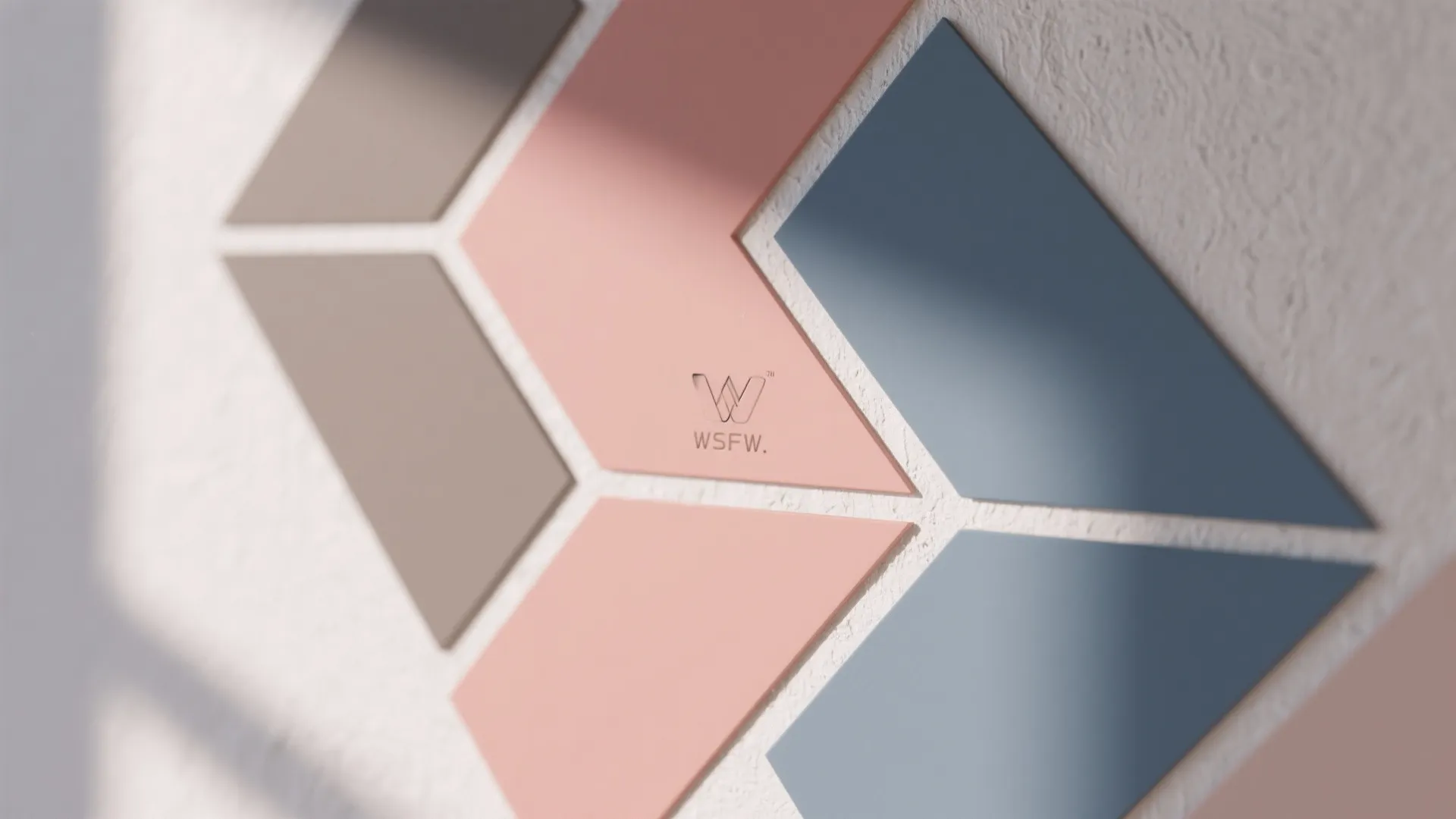 Geometric wall stickers in blue and pink tones creating a modern pattern on a white wall