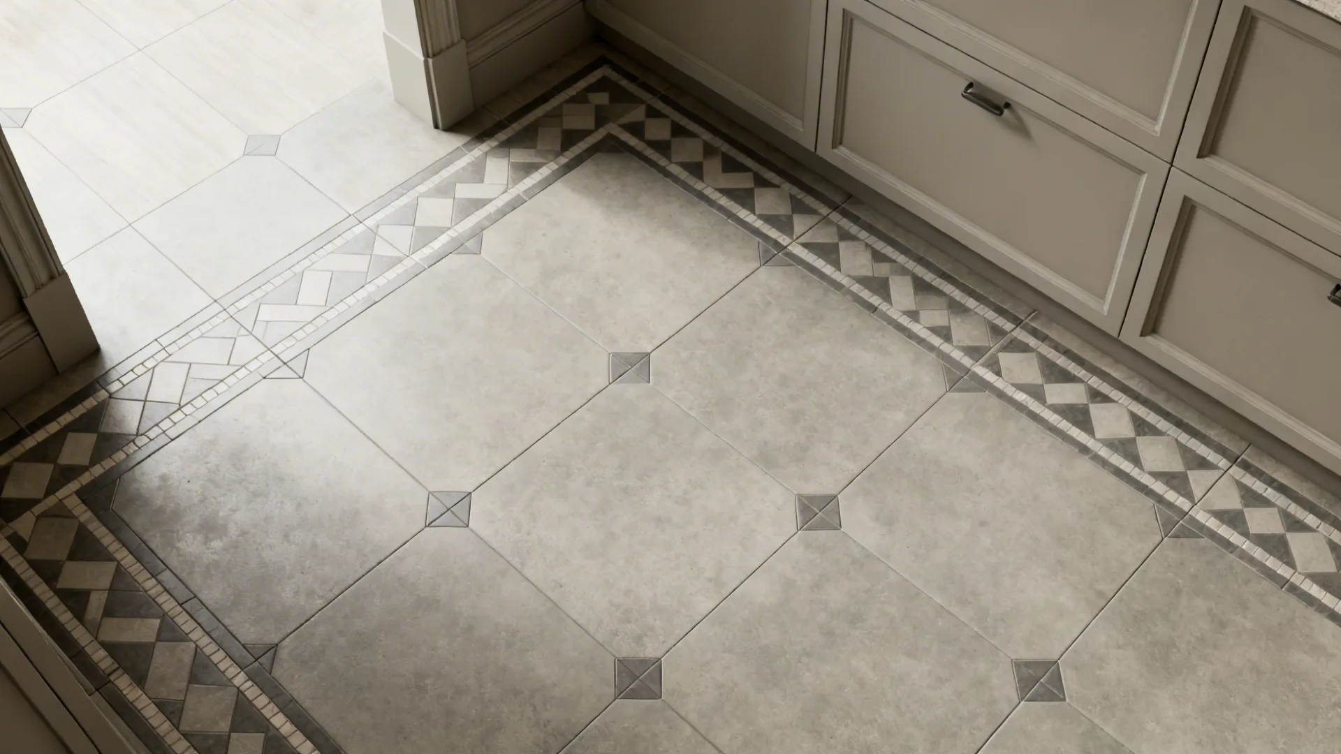 Top-down view of muted geometric floor tile pattern aligned at walls and cabinets.