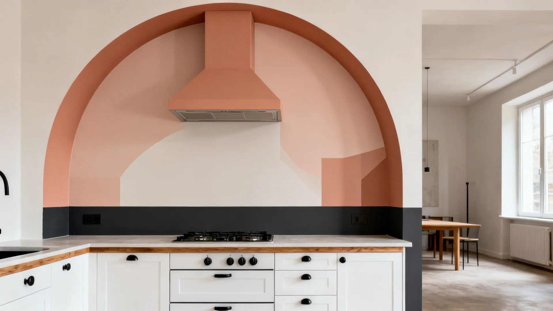 Matte terracotta arc and charcoal band decals define a kitchen zone in an open-plan studio.