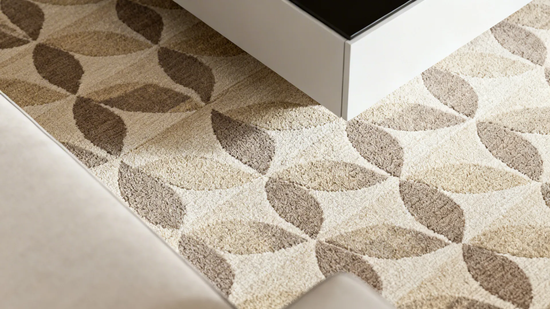 Subtle beige and taupe geometric rug pattern shown at a scale suitable for a seating area.