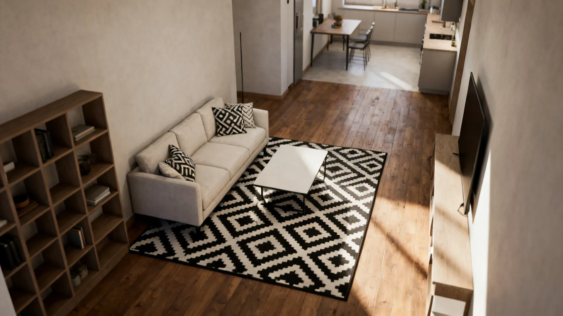 Open plan room layout with living area geometric rug sofa bookshelf and kitchen in background