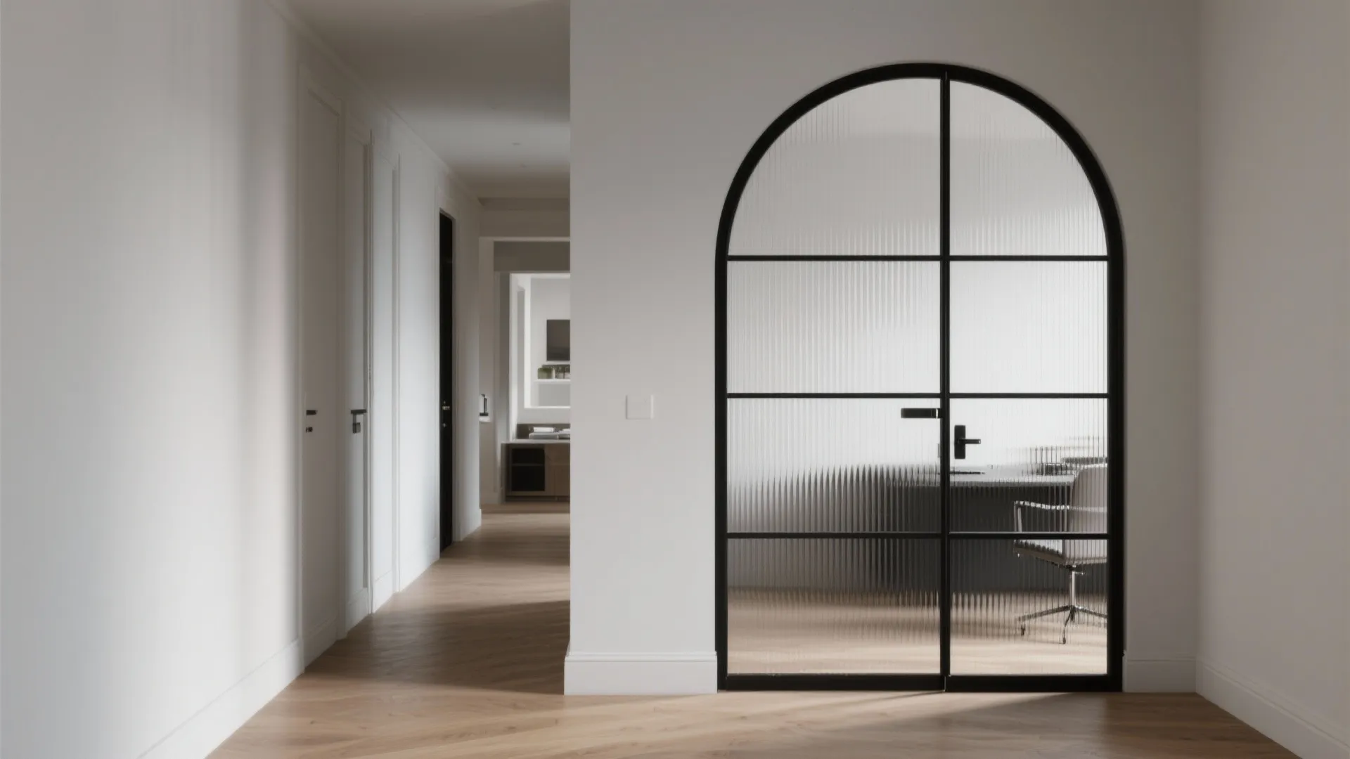 Modern white hallway with wooden floor and arched black metal frame glass door to office
