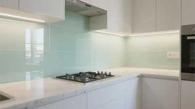 Modern Kitchen with Mint Glass Backsplash & Sleek White Cabinetry