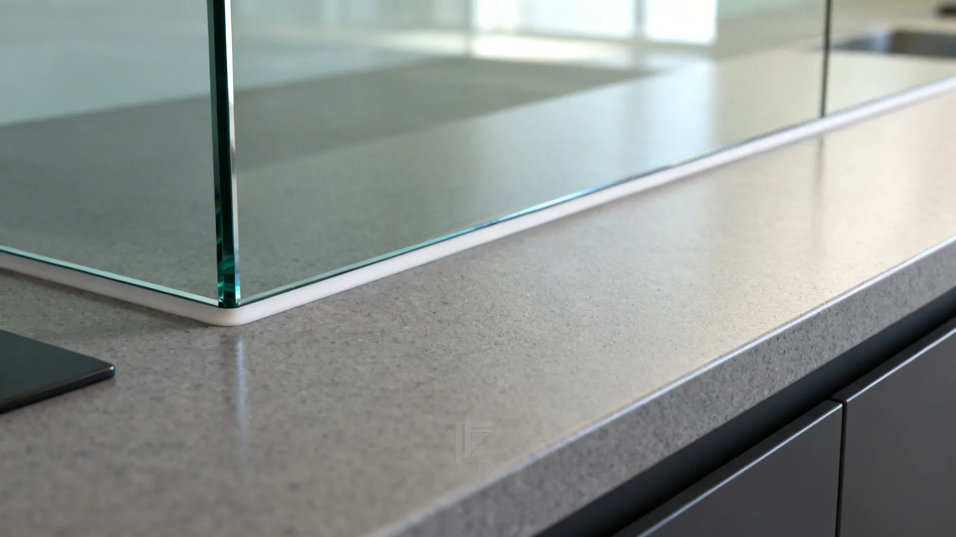 Close-up of low-iron glass backsplash edge aligning cleanly with a matte quartz countertop.