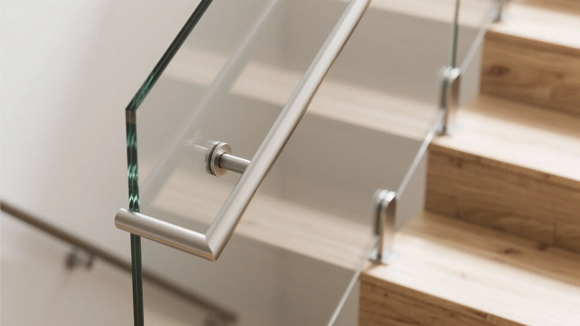 Modern wooden staircase with clear glass railing and silver metal handrail in a bright home