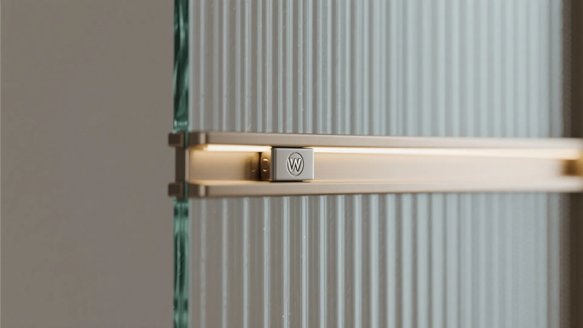 Close up of a textured glass door with a metal handle featuring built in warm lighting