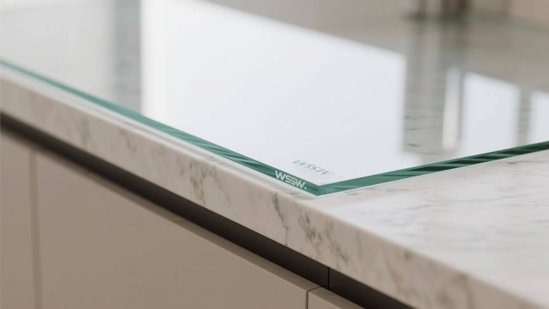 Close up view of tempered glass protector placed on a white marble kitchen countertop surface detail