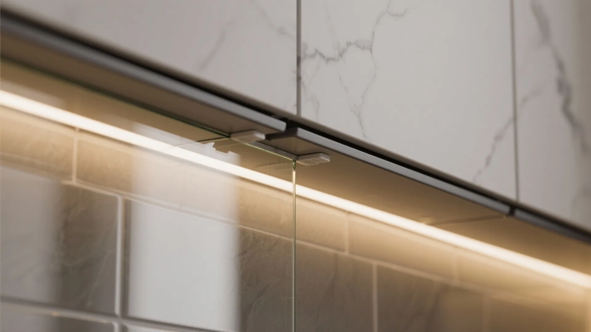 Modern white marble kitchen cabinet with warm light fixture installed above a clear glass panel