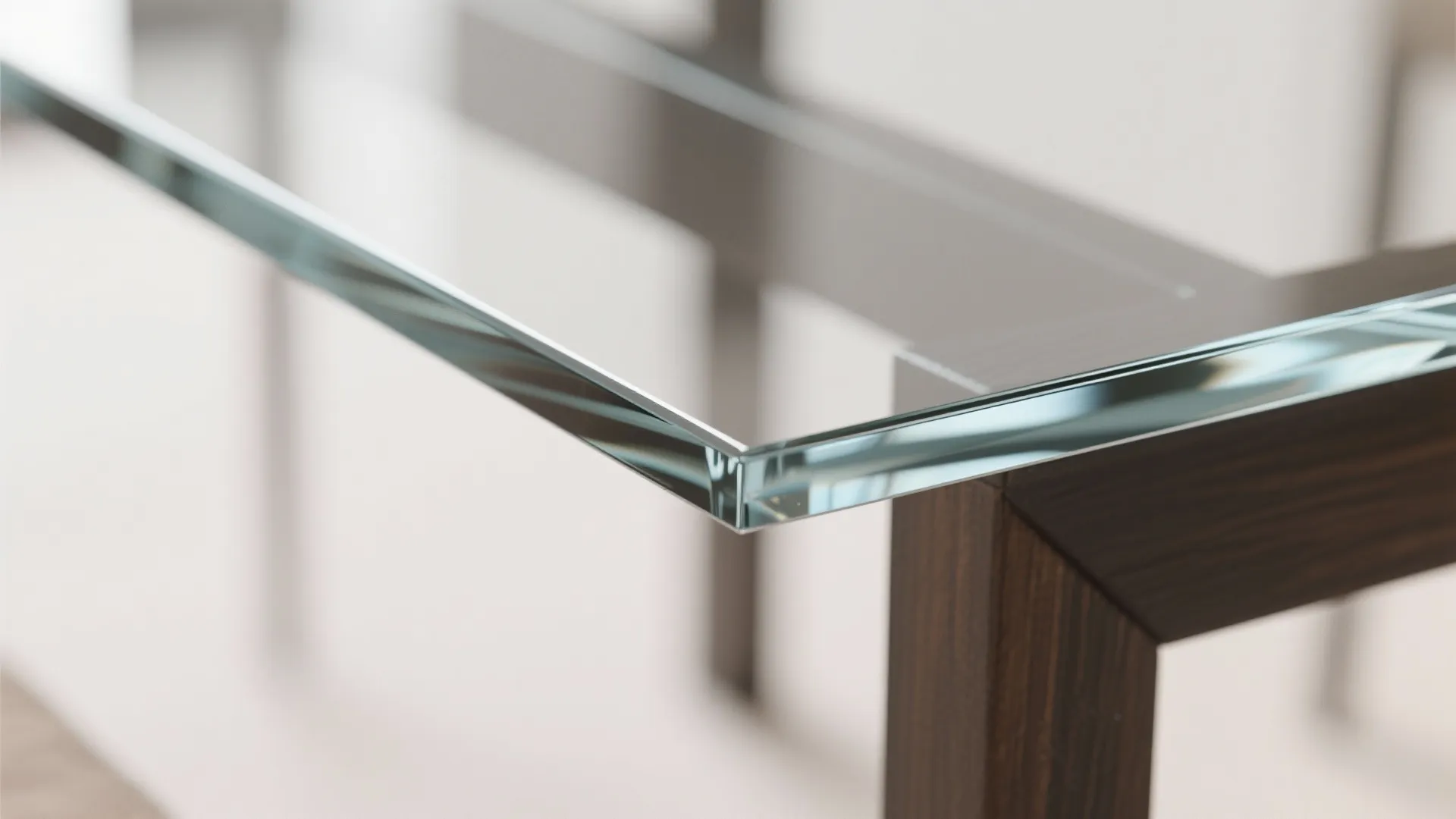 Close up of smooth clear glass table top with dark wooden frame and light background