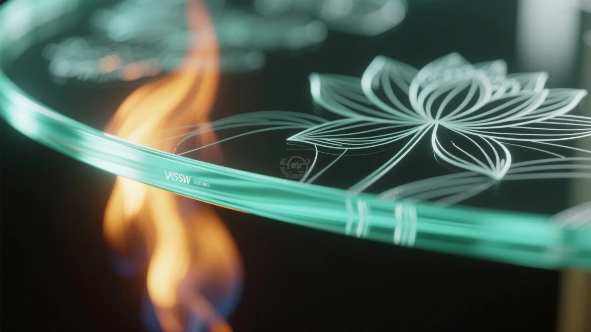 Close up of etched glass surface with flower pattern and orange light in the background
