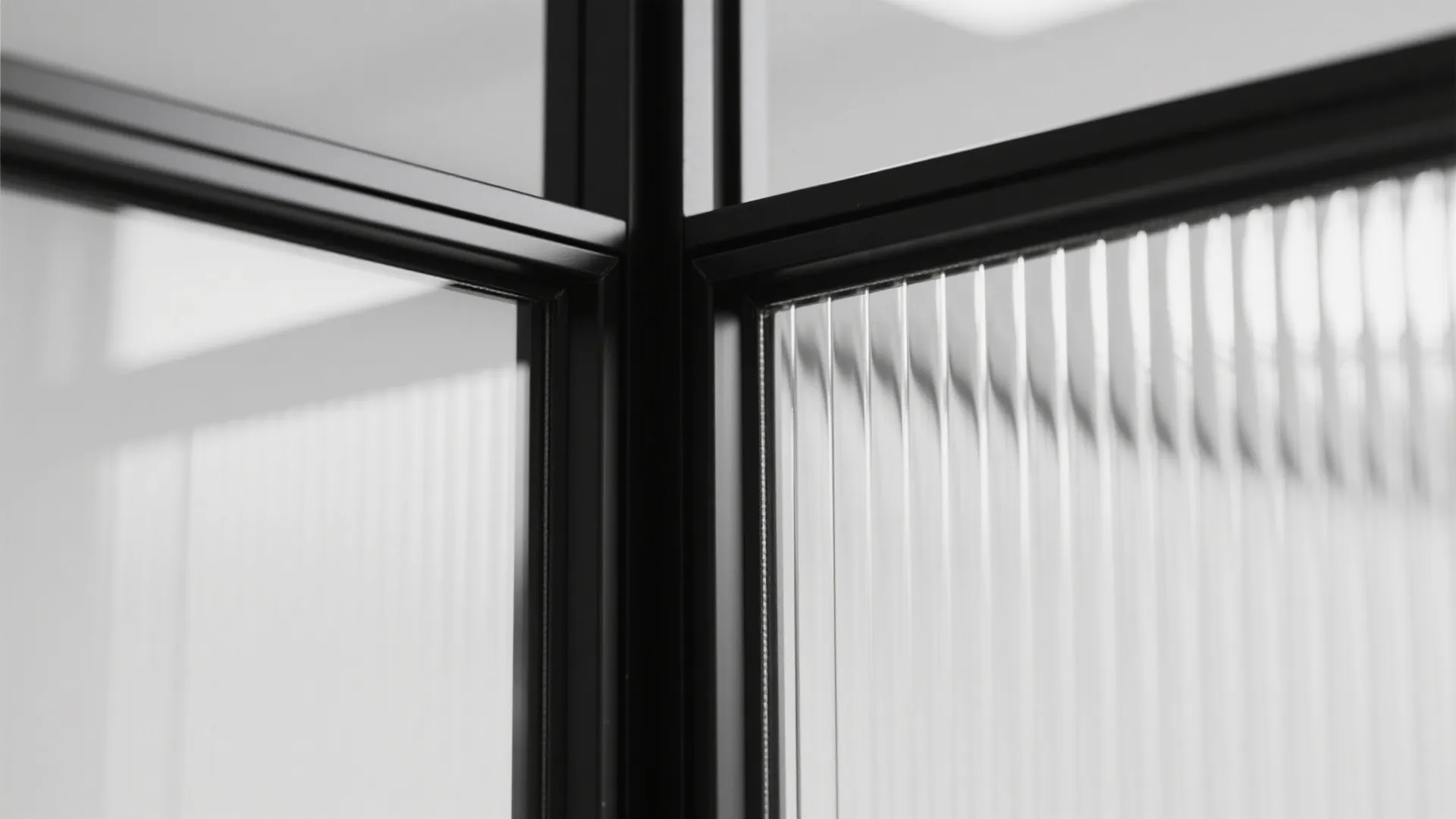 Macro of black metal frame and laminated glass junction in a partition wall.