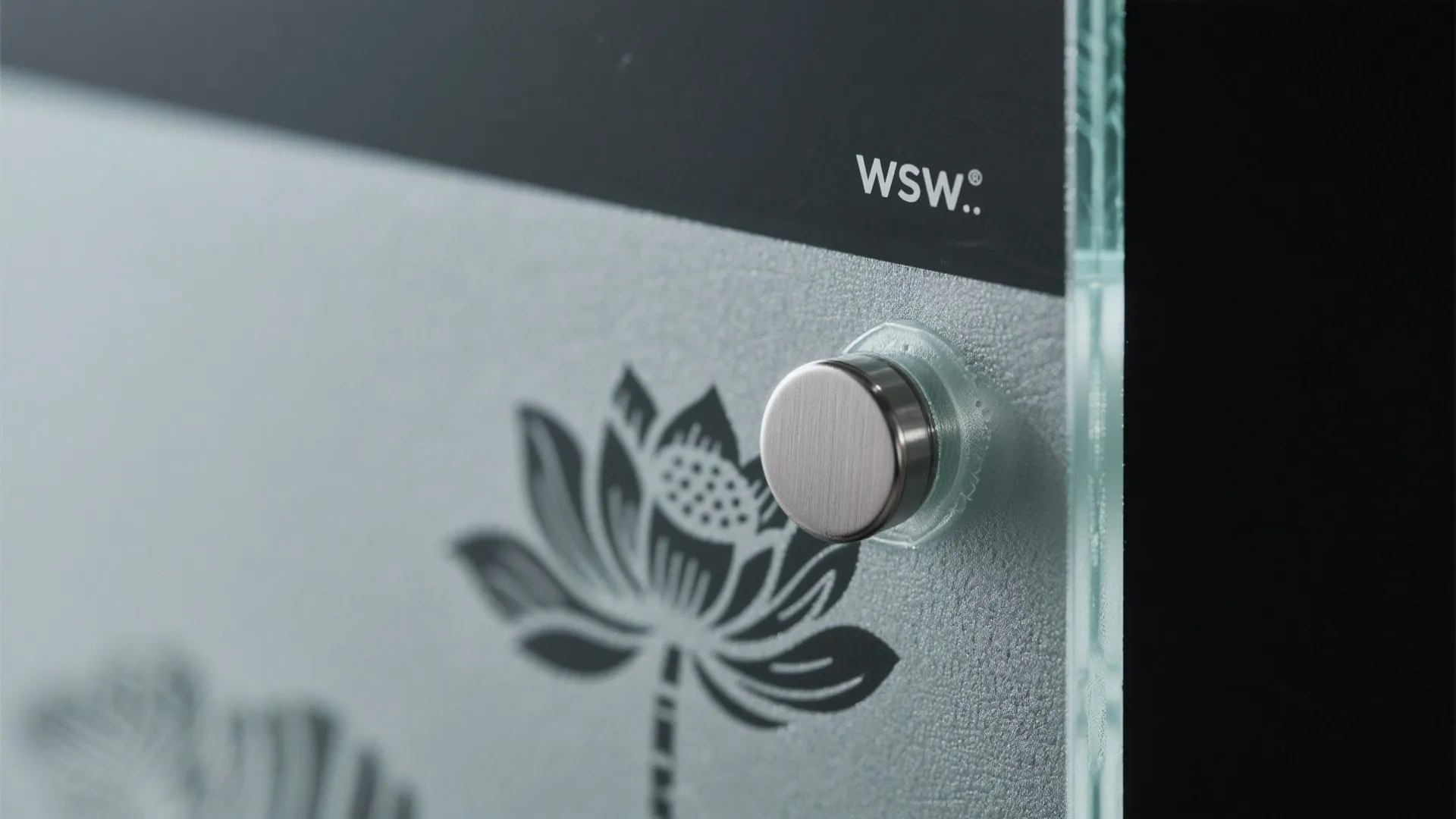 Close up view of frosted glass panel with black lotus flower print and metal hardware