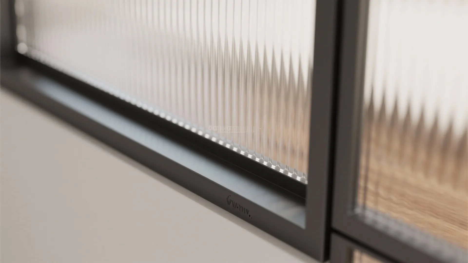 Close up view of ribbed glass panel with black metal frame showing texture and light