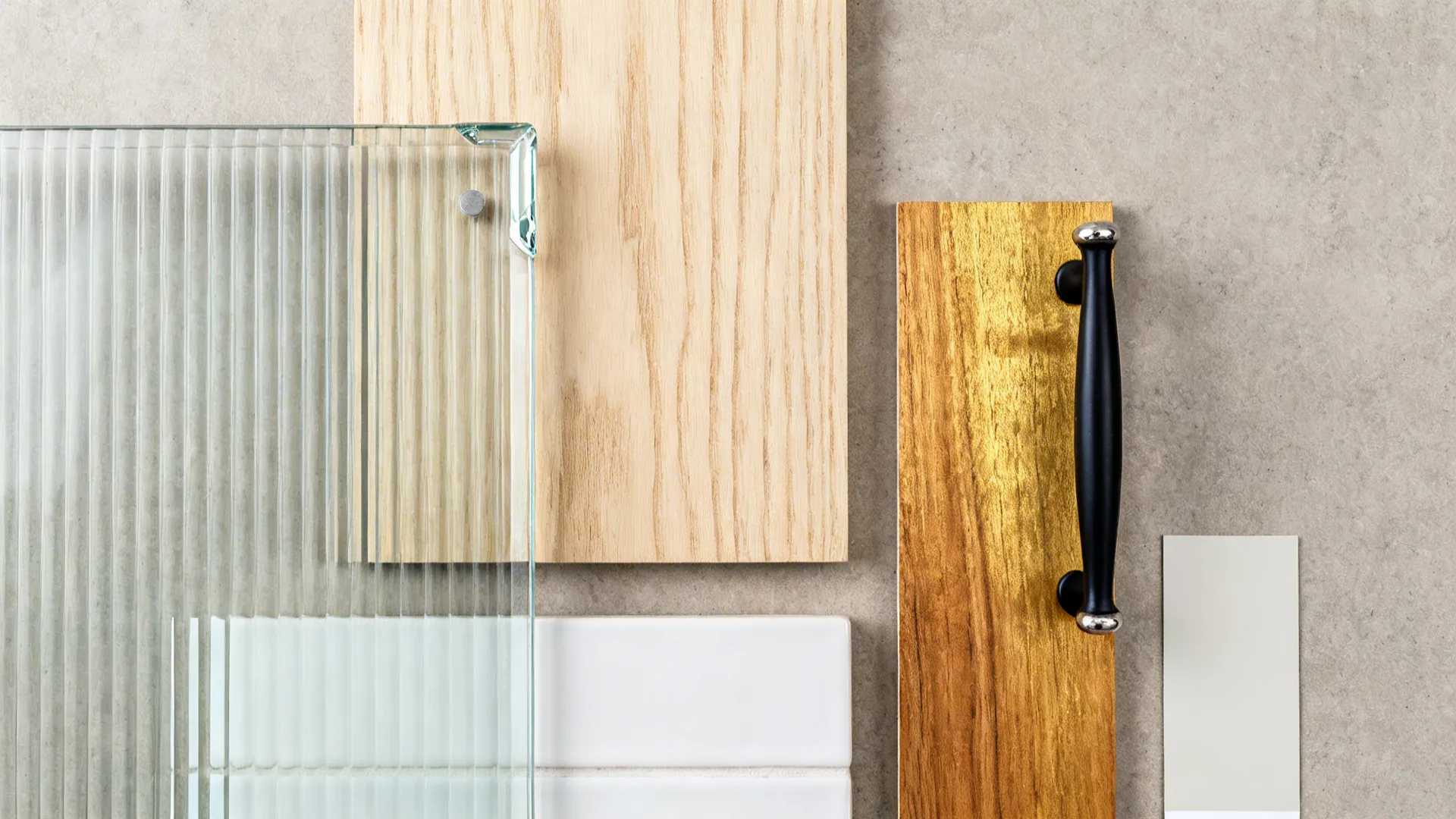 Top-down palette with reeded glass, birch plywood, wood, black hardware, and white tile.