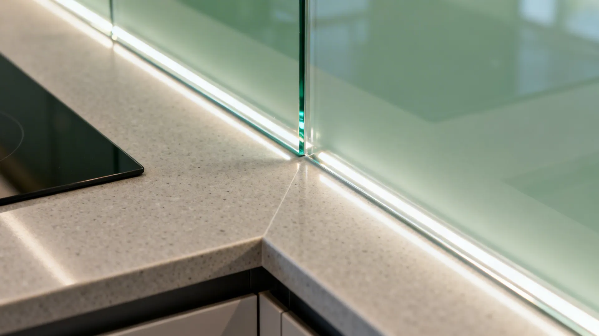 Close-up of low-iron back-painted glass meeting a matte quartz countertop edge.