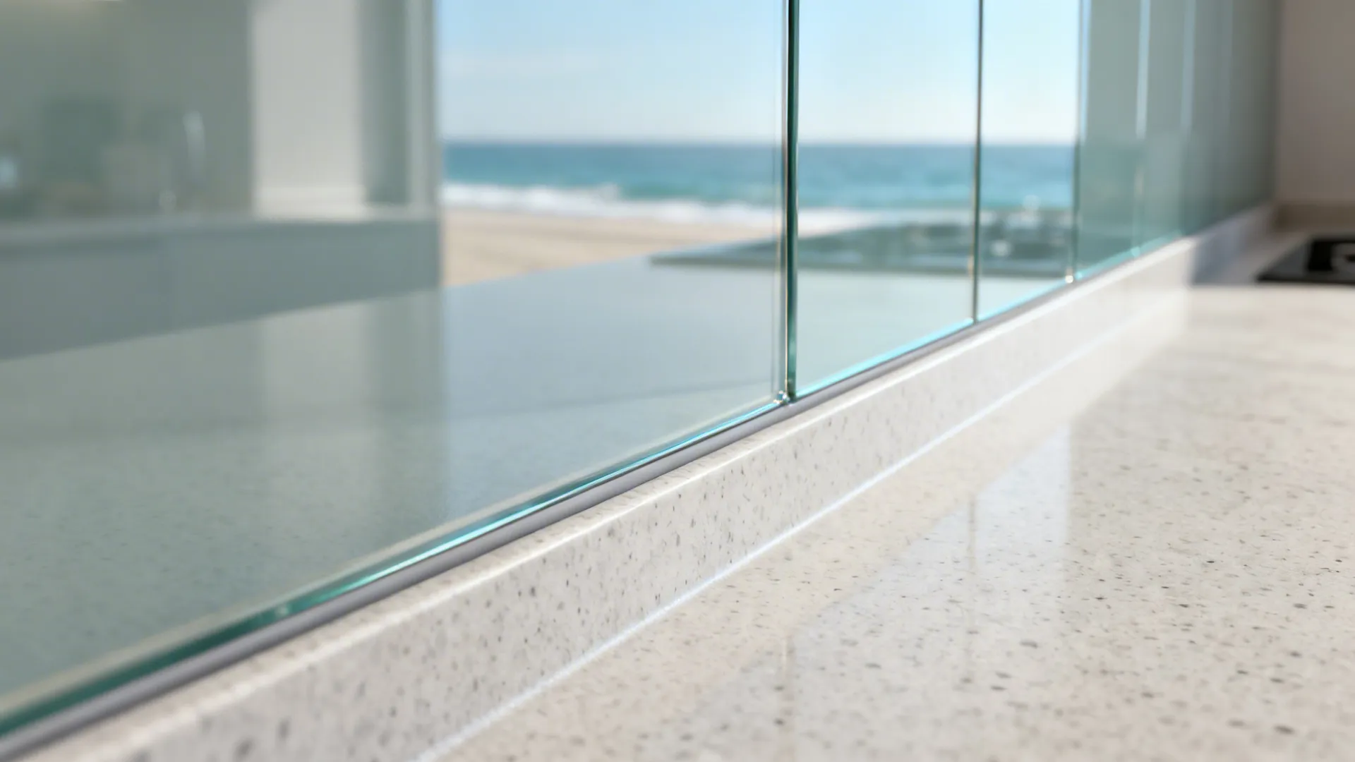 Close-up of satin glass backsplash meeting matte quartz with a clean joint.