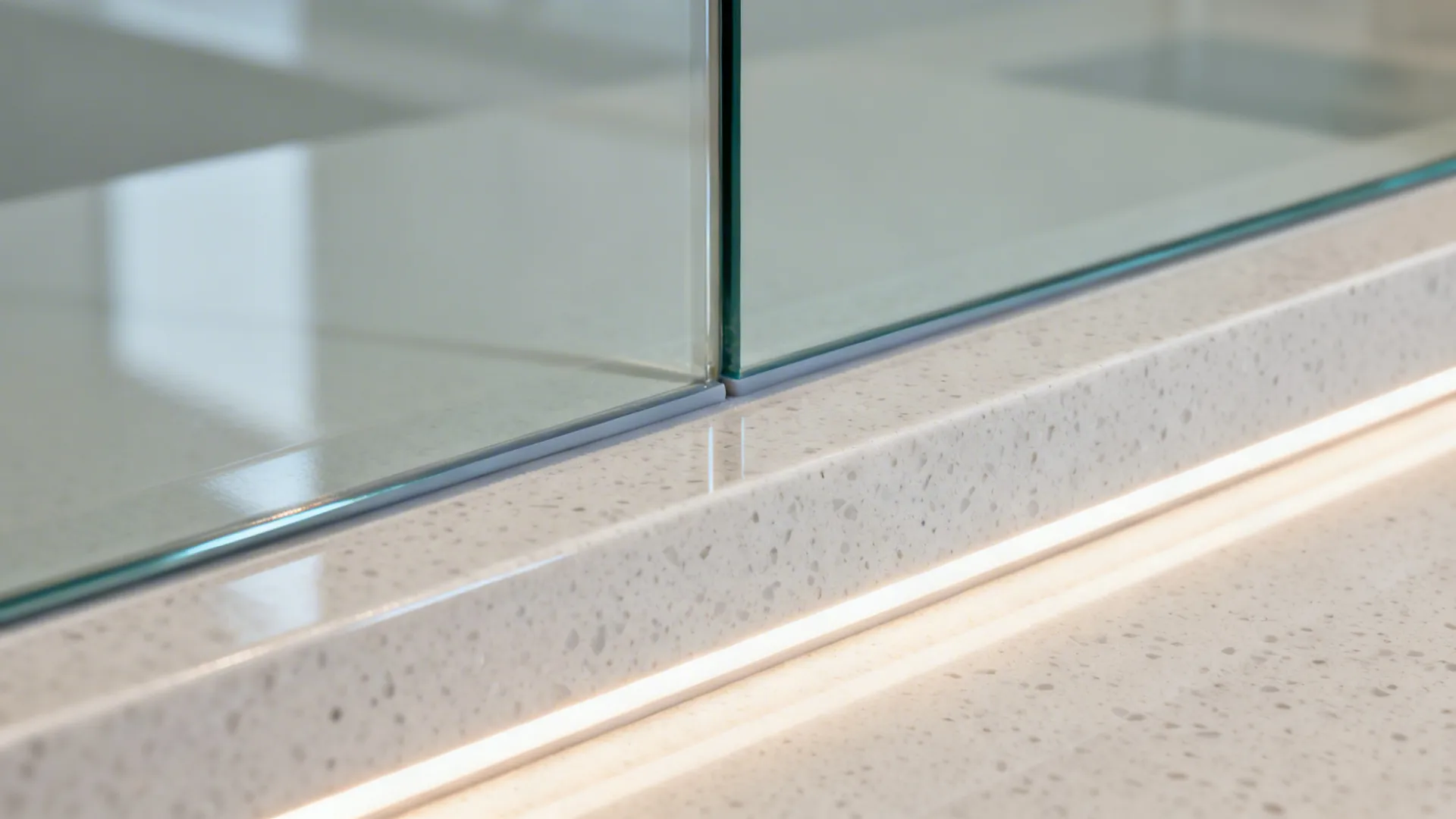 Glass backsplash and bright counters for airy light