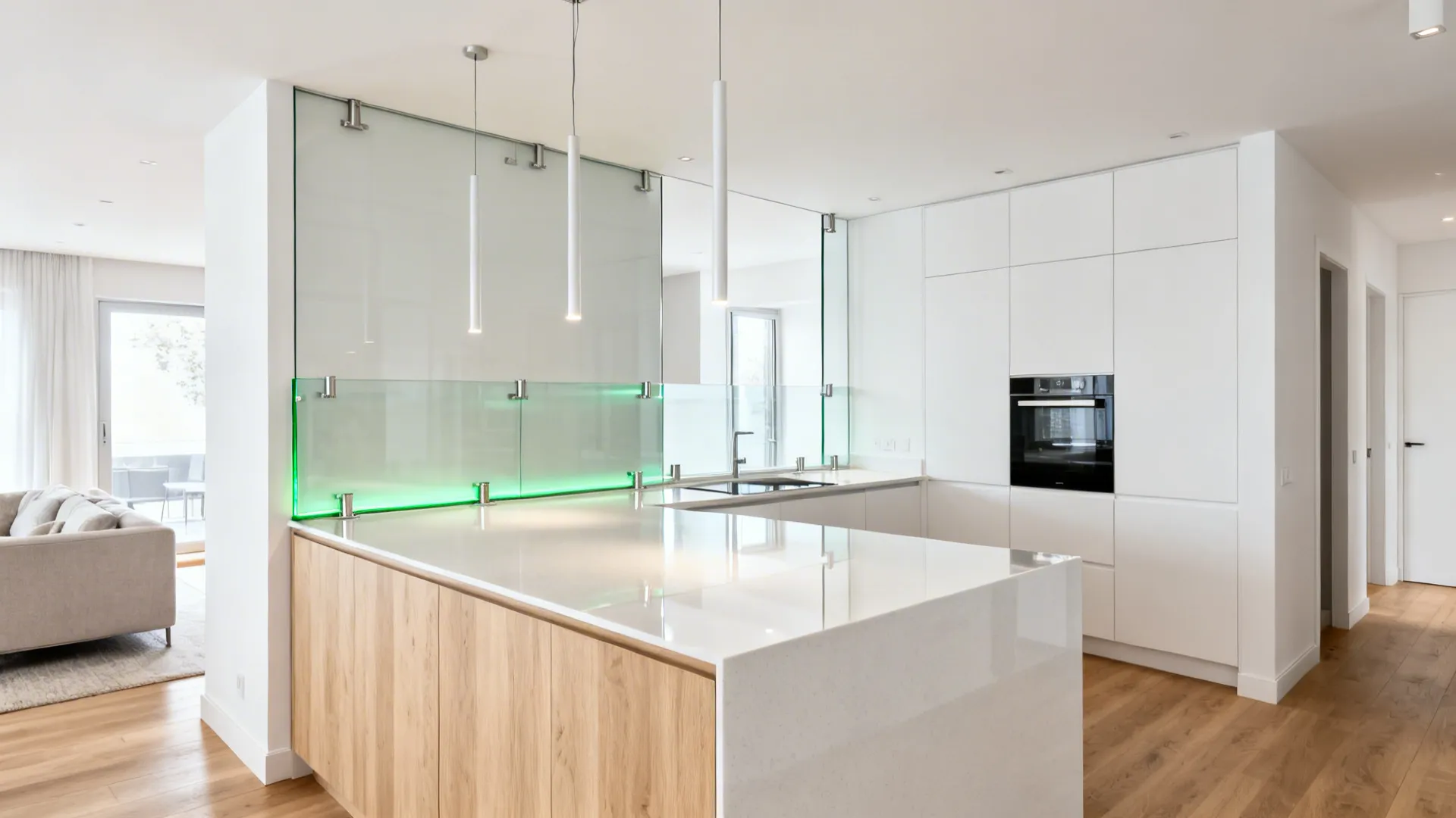 L-shaped island with a low-iron glass return panel separating kitchen and living area.