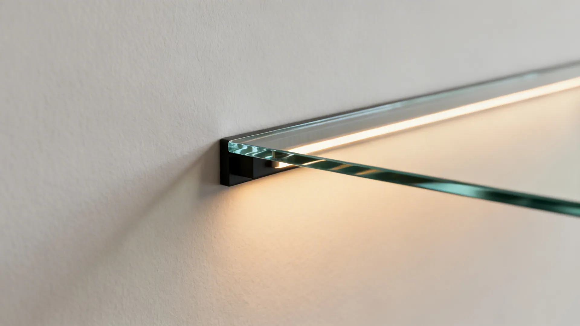 Close-up of low-iron glass and warm LED shelf lighting with concealed hardware.