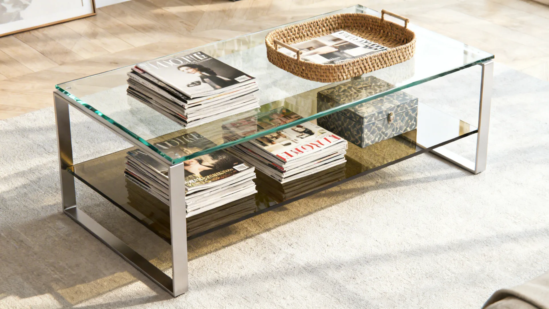 Glass coffee table with a lower smoked-glass shelf holding magazines and a woven tray for storage.