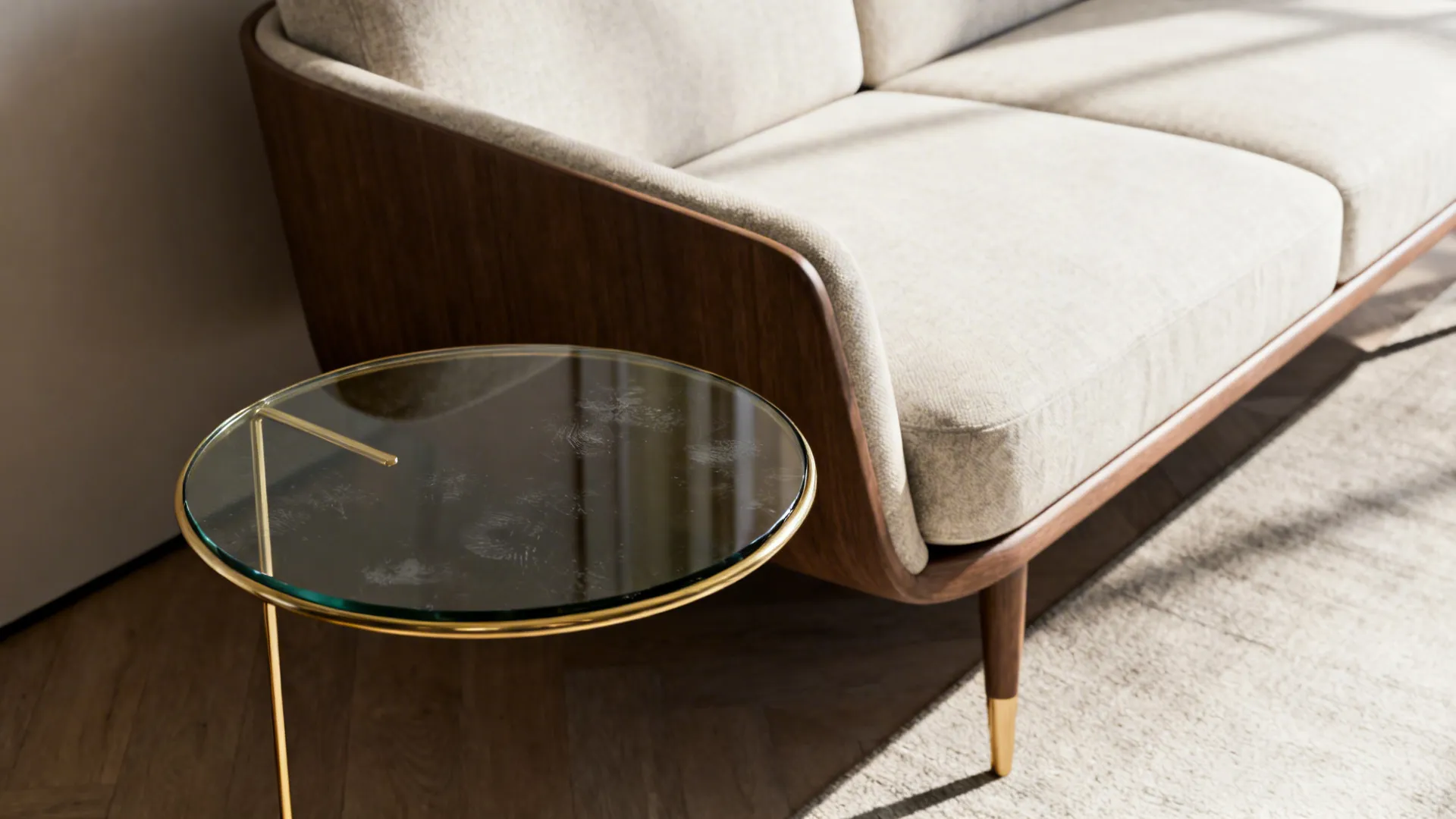 Glass-topped round side table with a thin metal frame beside a sofa, modern and airy.