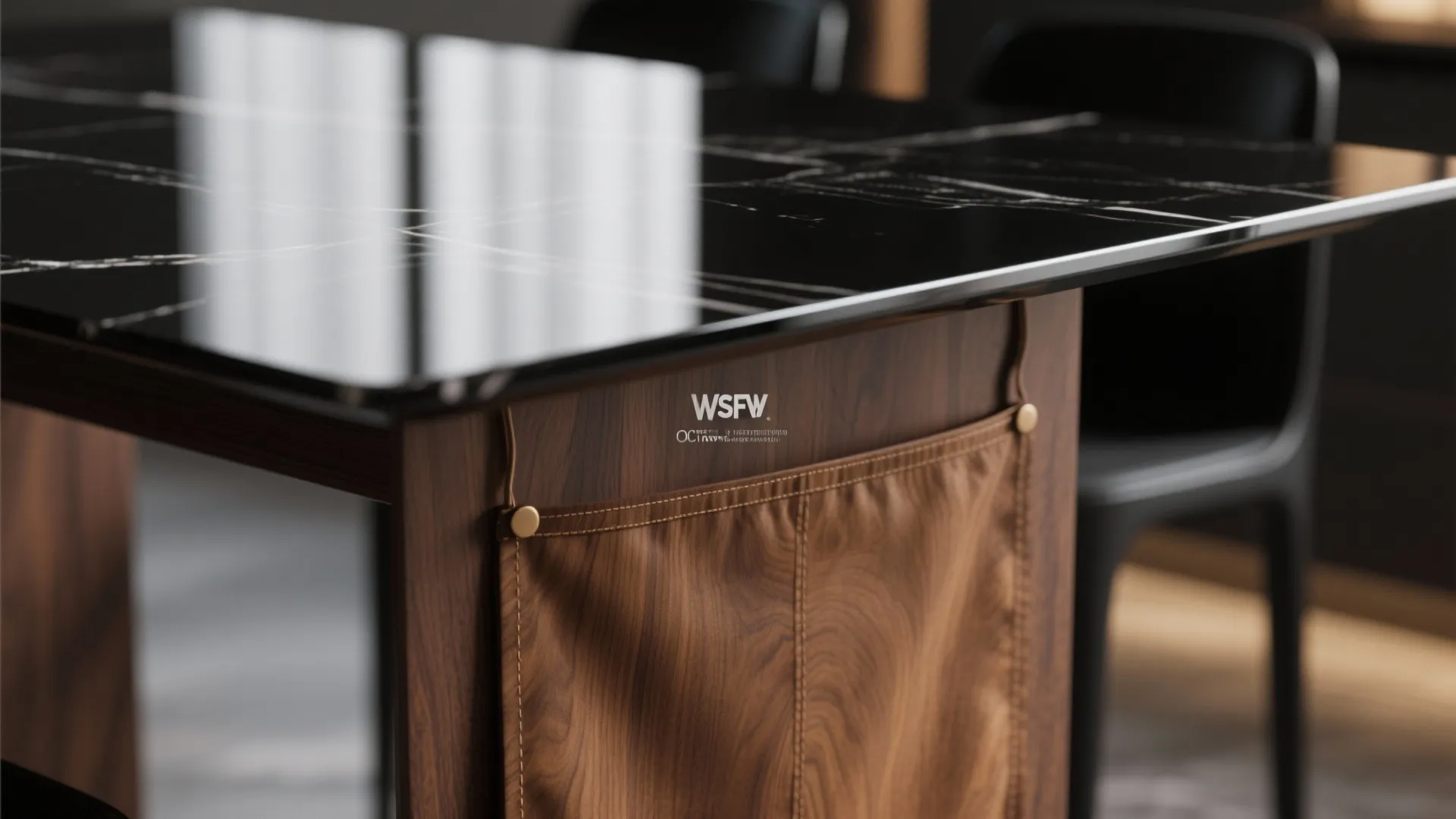 Close up of black marble table top with wooden base and brown leather storage pocket