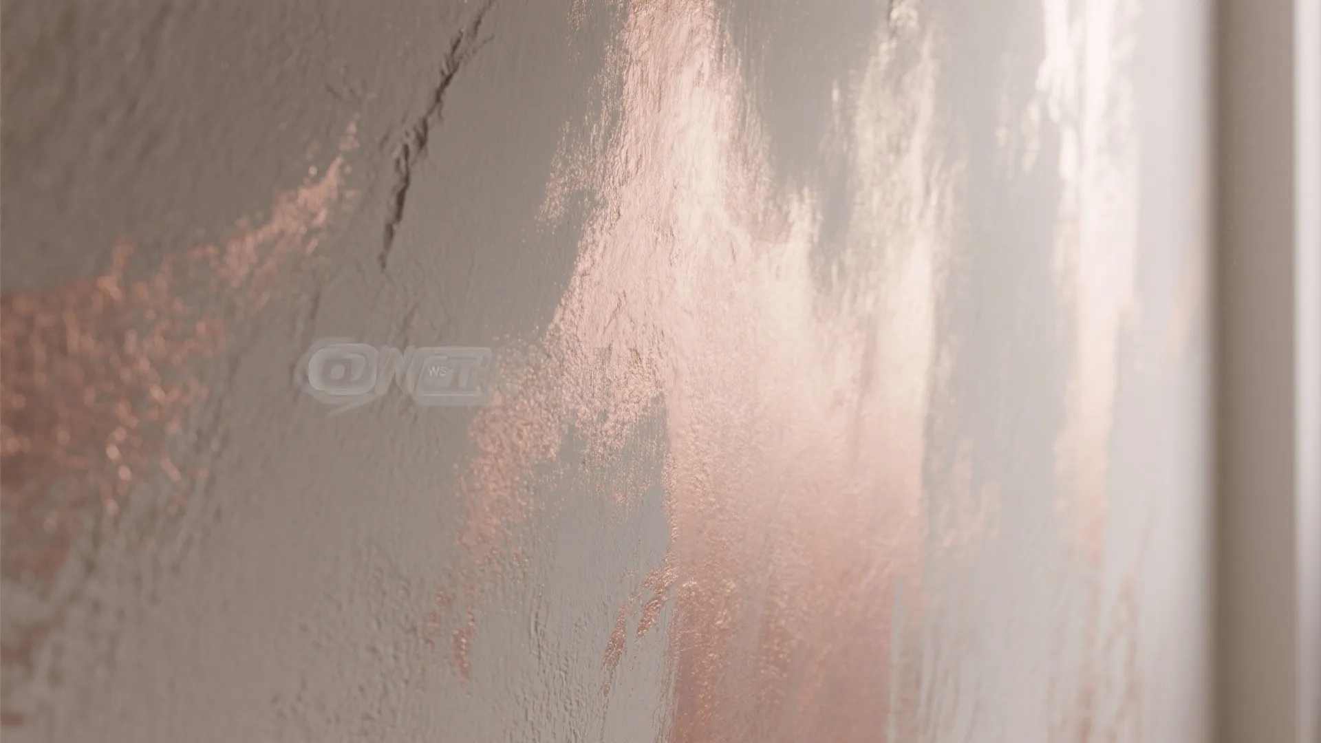 Close up view of rose gold metallic paint applied to a textured white plaster wall surface