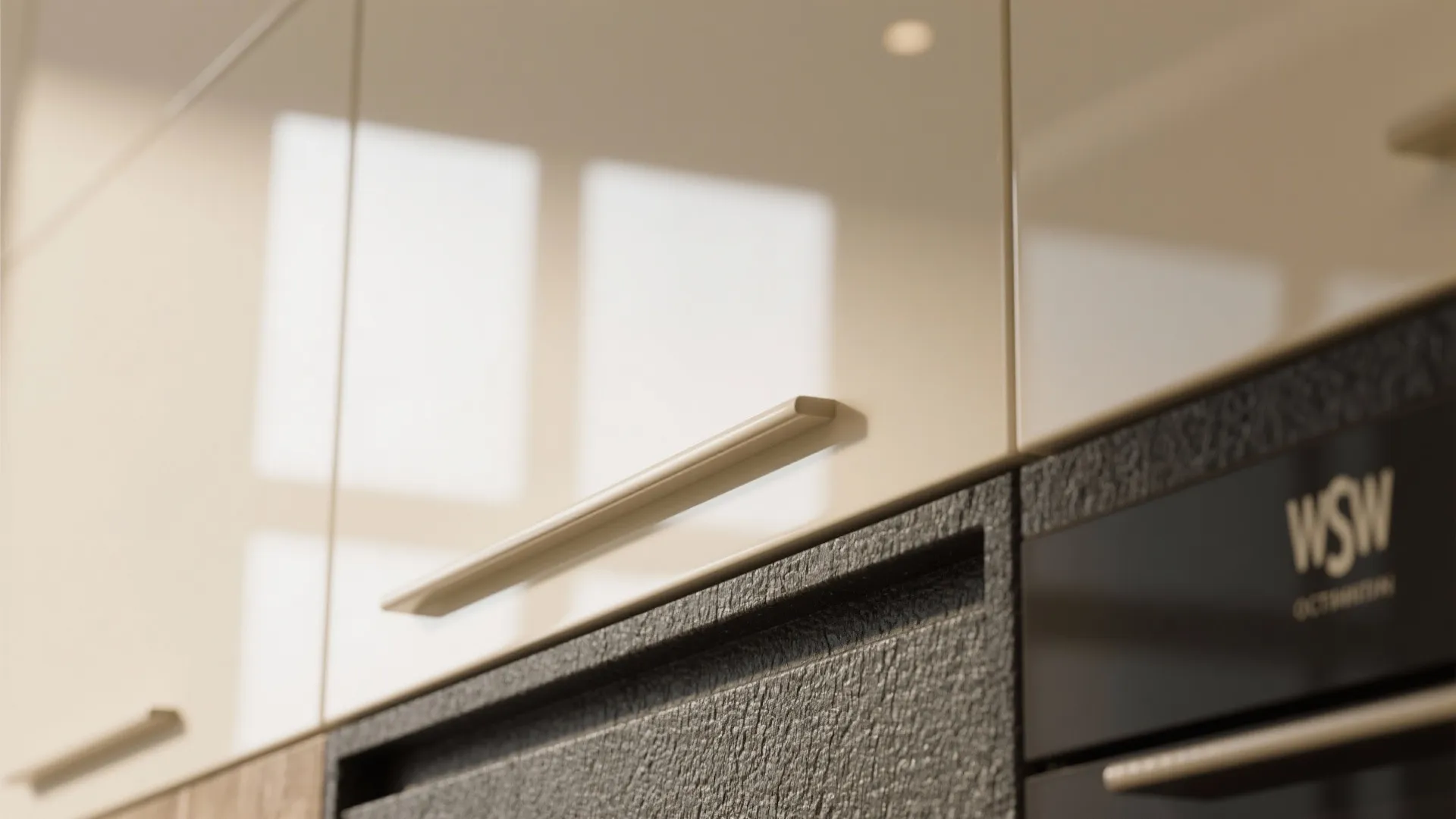 Close up of glossy beige kitchen cabinet doors with simple handles and black textured surface