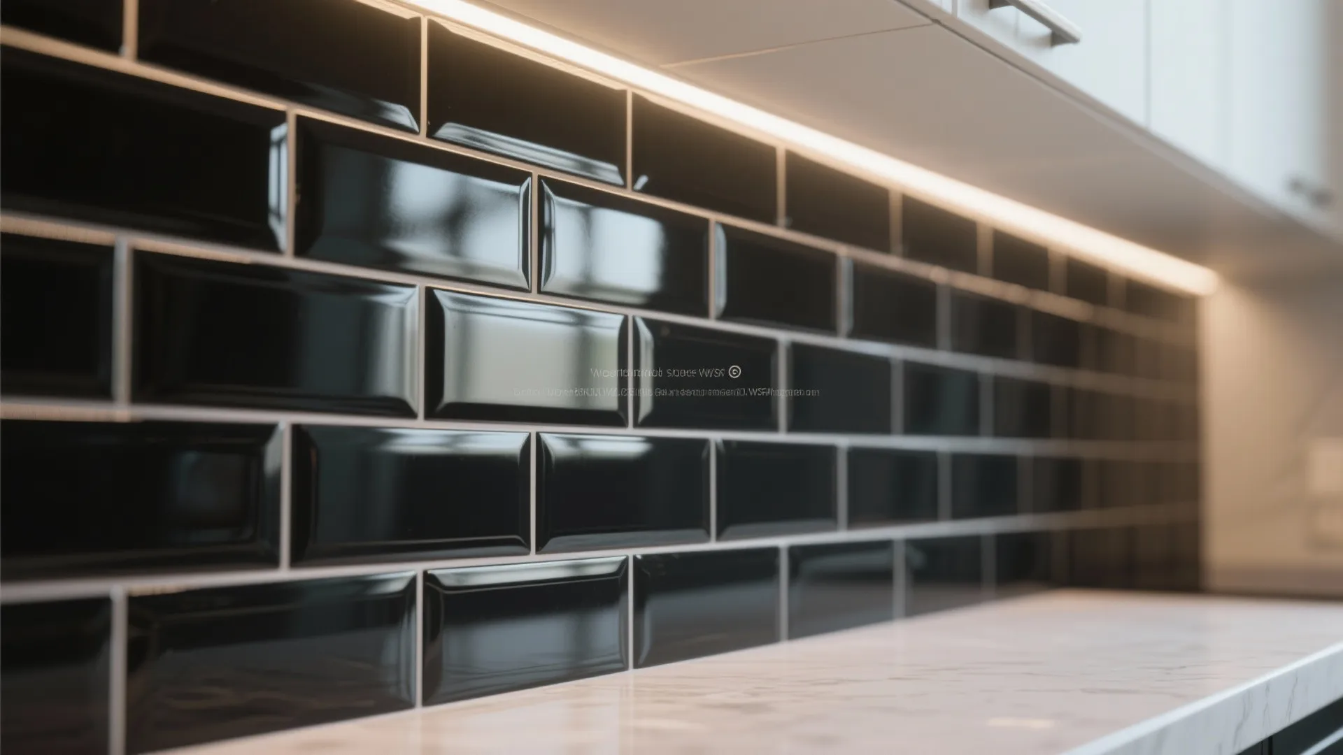 Close up of glossy black wall tiles with white grout on a modern kitchen counter wall