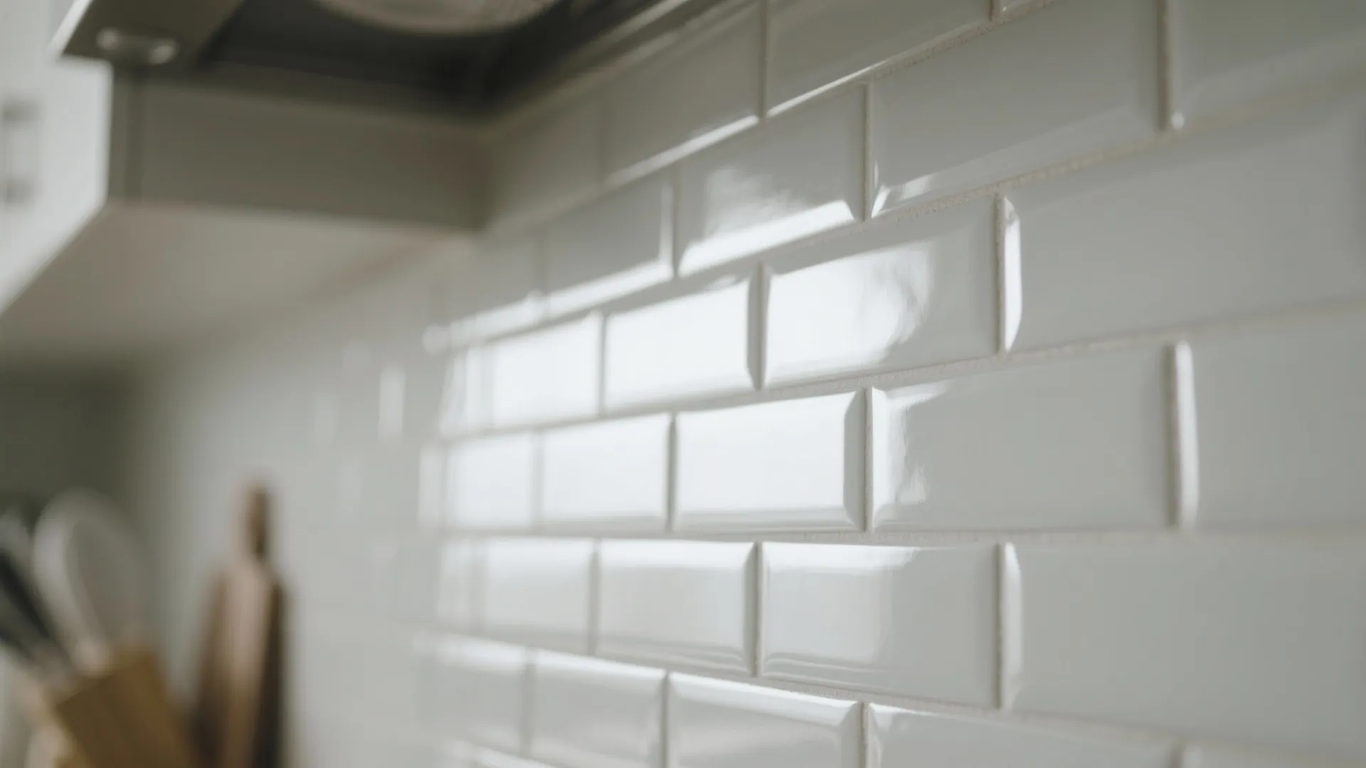 Close up view of white glossy rectangular wall tiles in a modern bright kitchen room