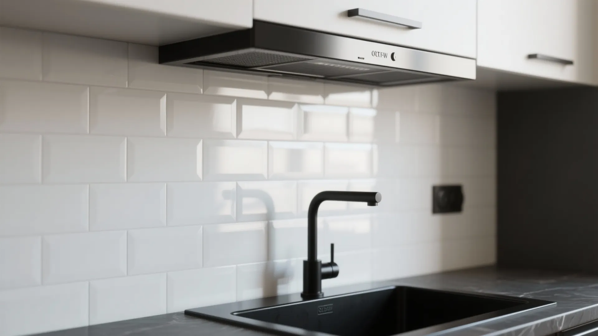 White subway tile backsplash with black faucet and sink under white cabinets and black hood