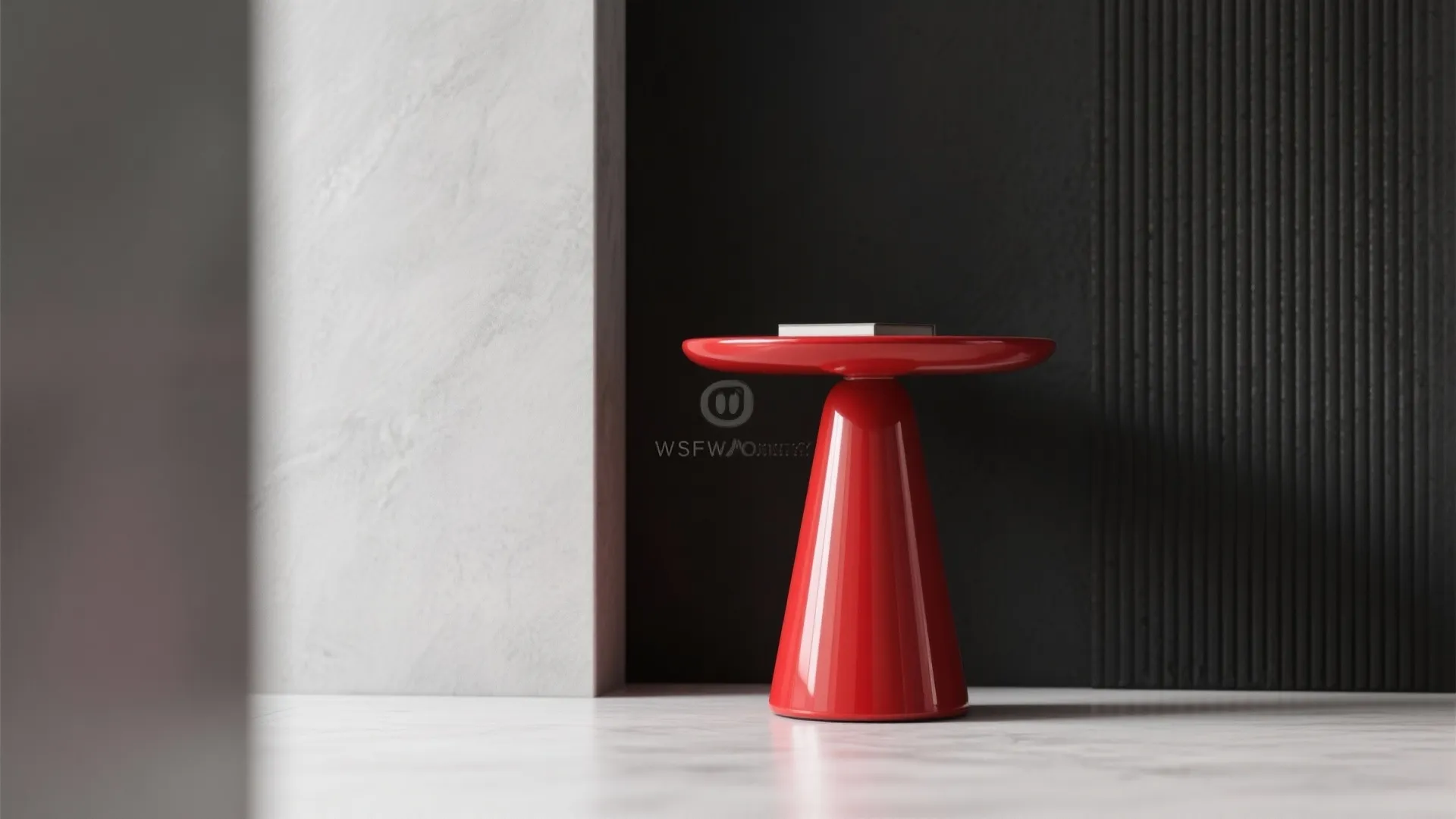 Small red glossy side table standing against a black textured wall and white stone column